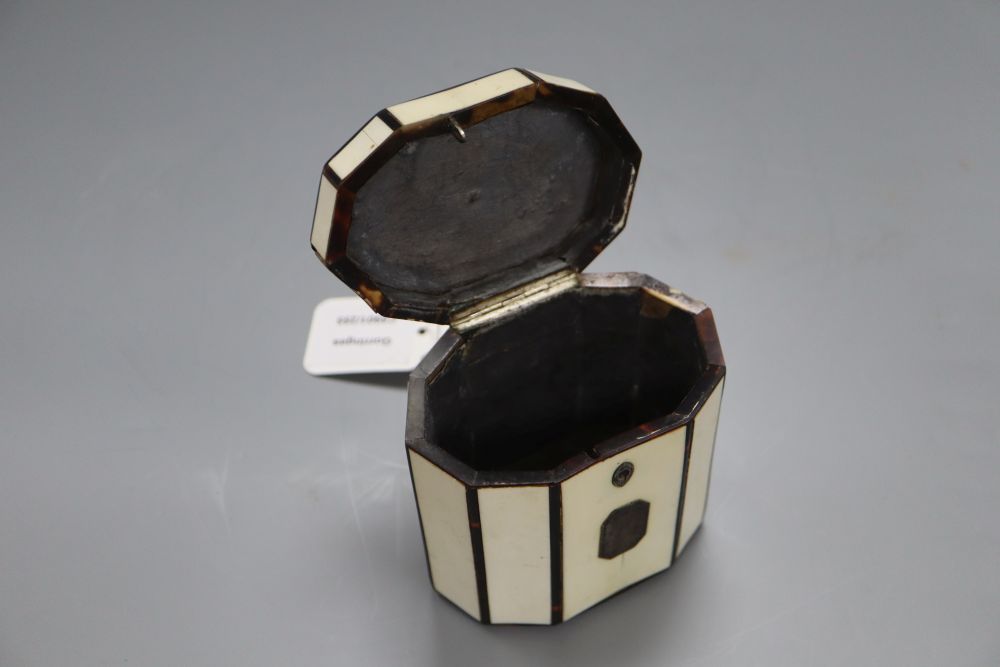 A George III octagonal ivory and tortoiseshell veneered tea caddy, height 10cm